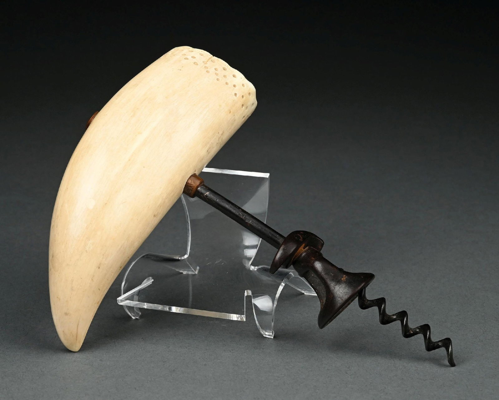 SCRIMSHAW CORKSCREW: C. 1880s–1920. Scrimshaw corkscrew featuring a whale’s tooth handle, a rare example of early sailors’ work. The tooth measures 6" long and is attributed to Von Maritime, Inc. Four mi