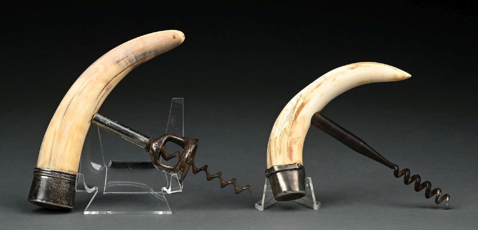 COLLECTION OF 2: TUSK CORKSCREWS: (A) C. 1880–1910. A boar or warthog tusk scrimshaw-carved corkscrew, likely sailor-made, fitted with a silver-toned metal cap and corkscrew mechanism. The cap is engraved with initials and shows