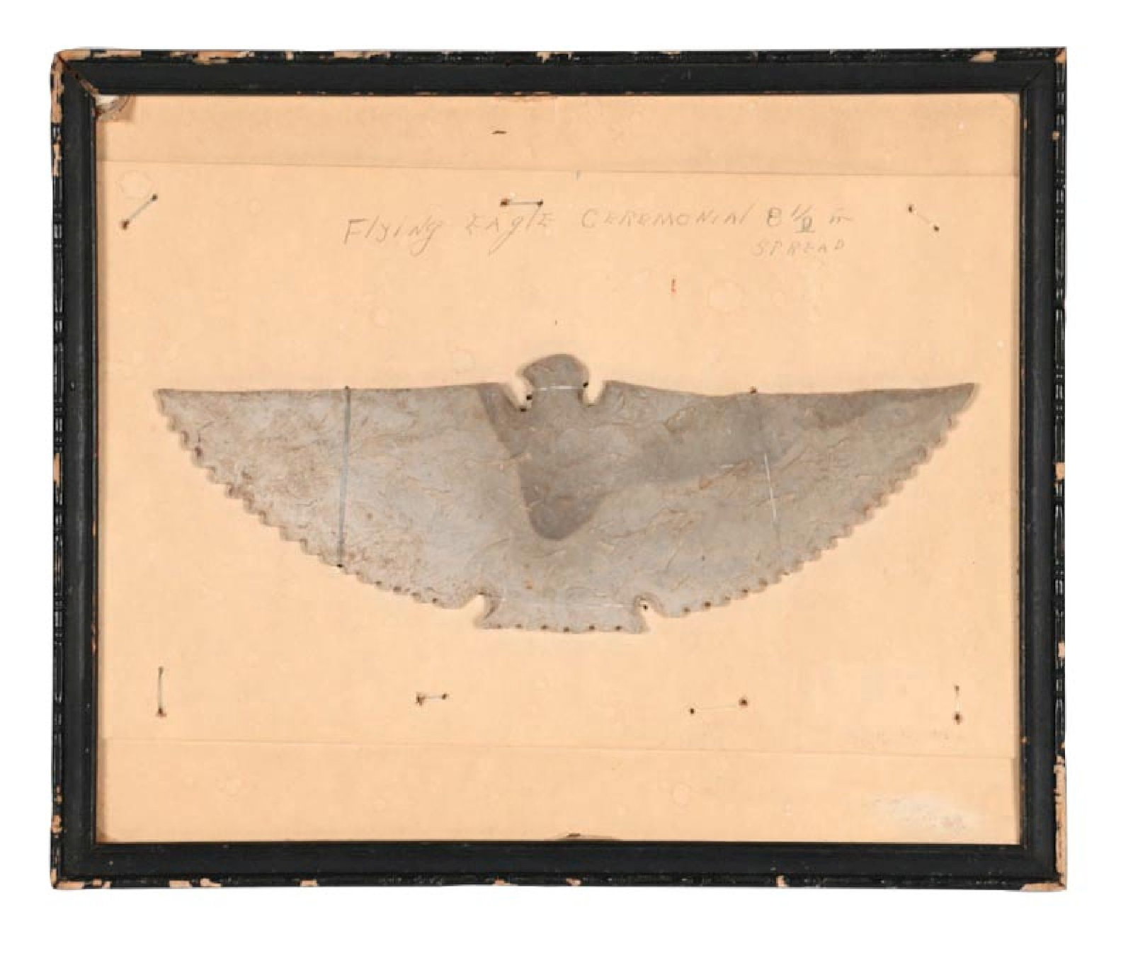 FLYING EAGLE CHIPPED CEREMONIAL STONE CARVING: C. 1880–1930. A carved stone flying eagle ceremonial plaque depicting an eagle with wings fully spread in low relief. The carving features stylized feather edges and a central body with