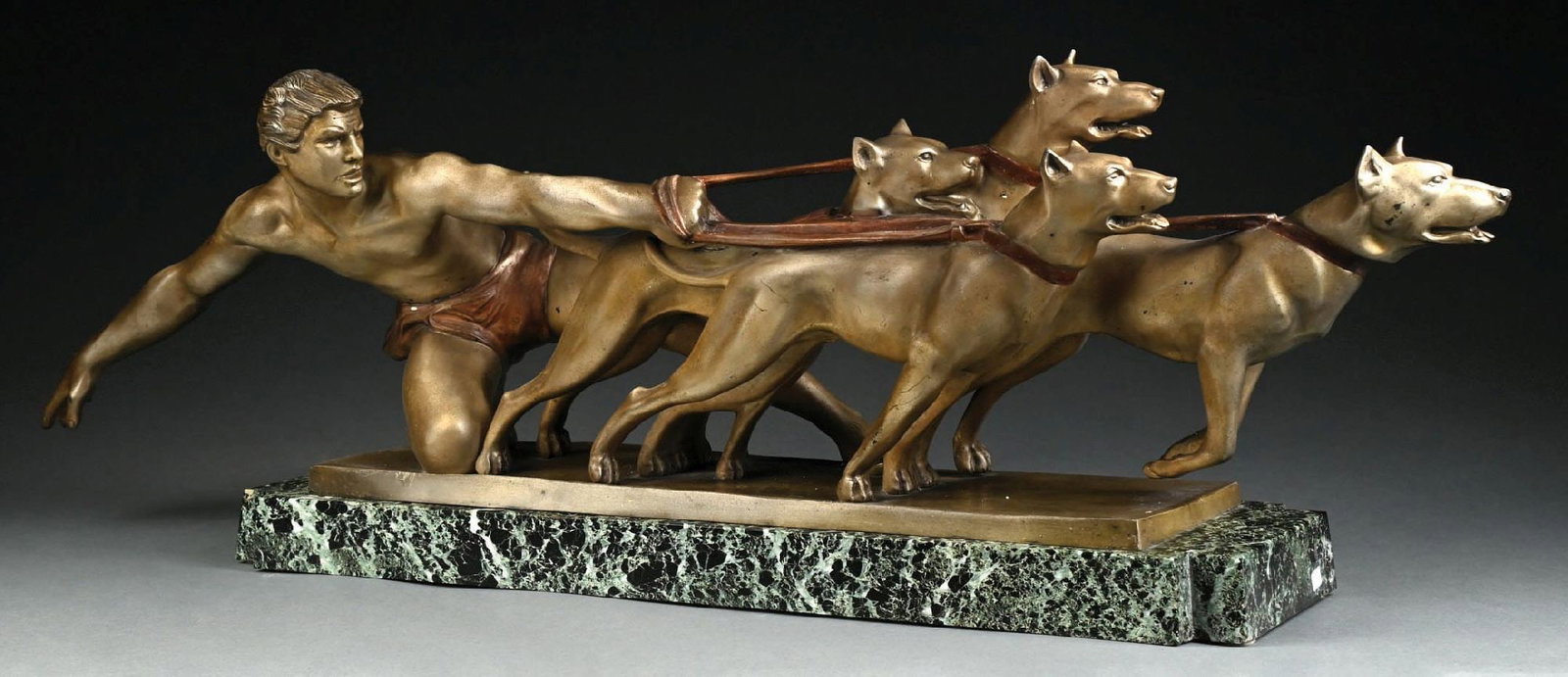 ALEXANDRE KÉLÉTY (HUNGARIAN, 1874–1940): Circa 1925-1930s. The Release A large Art Deco brass tone patinated figural bronze sculpture which is mounted on a long green veined marble base. Very heavy piece. Depicting a strong nude man strainin