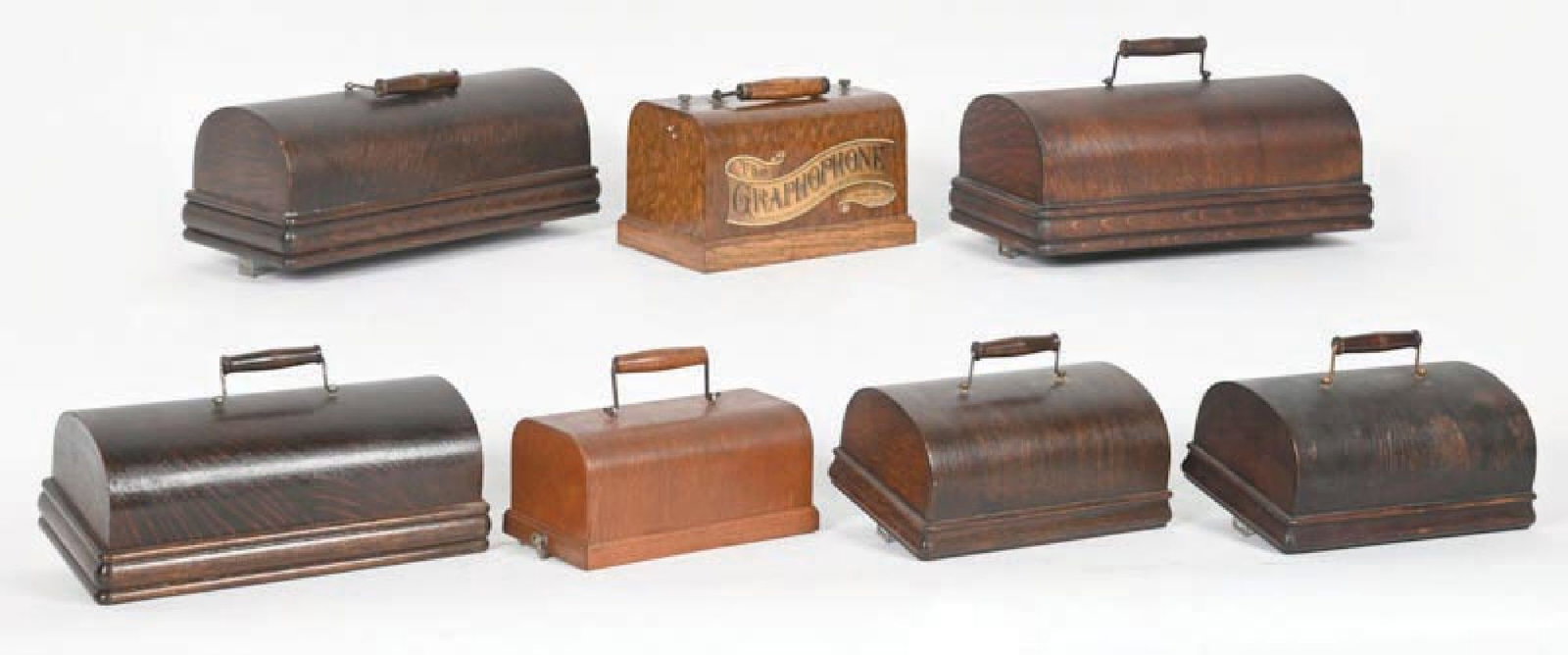 COLLECTION OF 7: CYLINDER PHONOGRAPH COVERS: Covers for various-sized cylinder phonographs, with conditions ranging from good to very good. Condition: (Good - Very Good). Dimensions: Largest: 14 - 1/2" x 7 - 3/4" x 9".