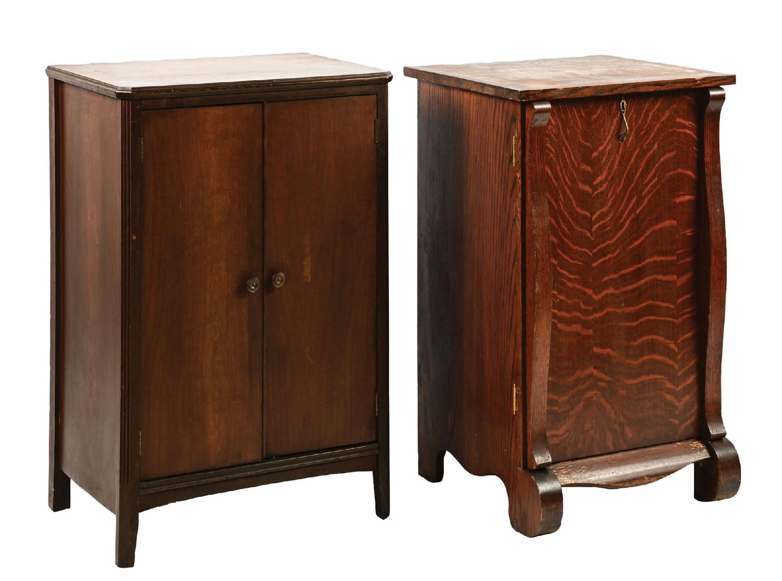 PAIR OF PHONOGRAPH STANDS: (A) An oak phonograph stand with Bombay front accents. It shows moderate wear overall, with interior shelving. (Good). (B) A double-door walnut phonograph stand with interior shelving and moderate wea