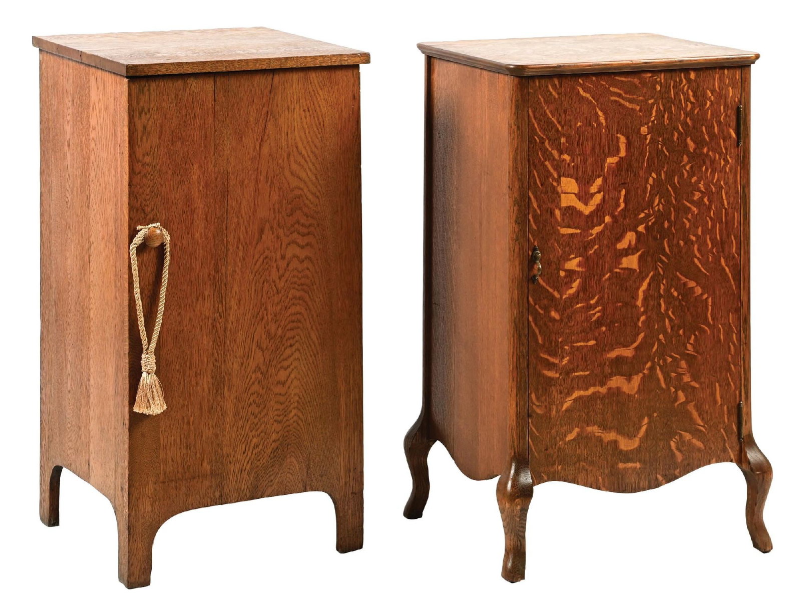 PAIR OF PHONOGRAPH STANDS: (A) An oak phonograph stand with front hardware, complete interior, and areas for record separation. It shows light wear overall. (Very Good). (B) An oak phonograph stand with interior shelving. It sh