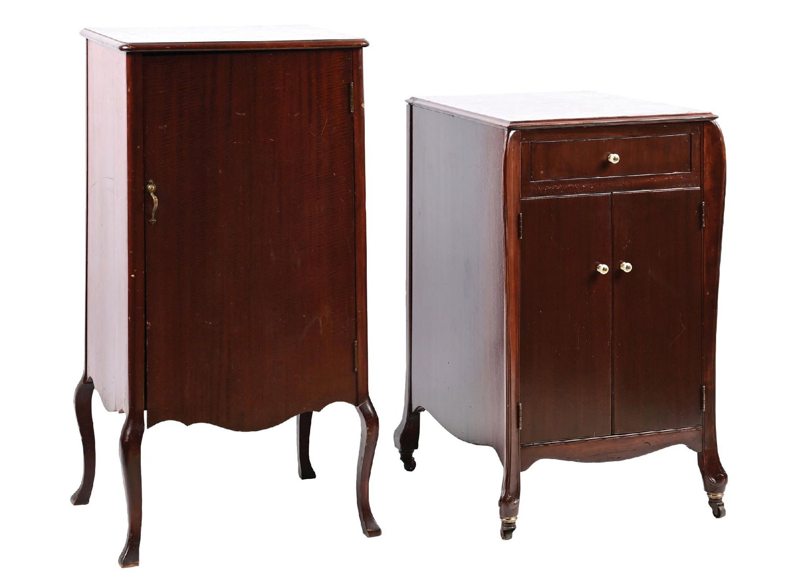 PAIR OF PHONOGRAPH STANDS: (A) A mahogany phonograph stand with an internal shelf and front door. It shows some scuffs and scrapes on the top from use. Light wear over the rest of the cabinet. (Good). (B) A phonograph stand wit