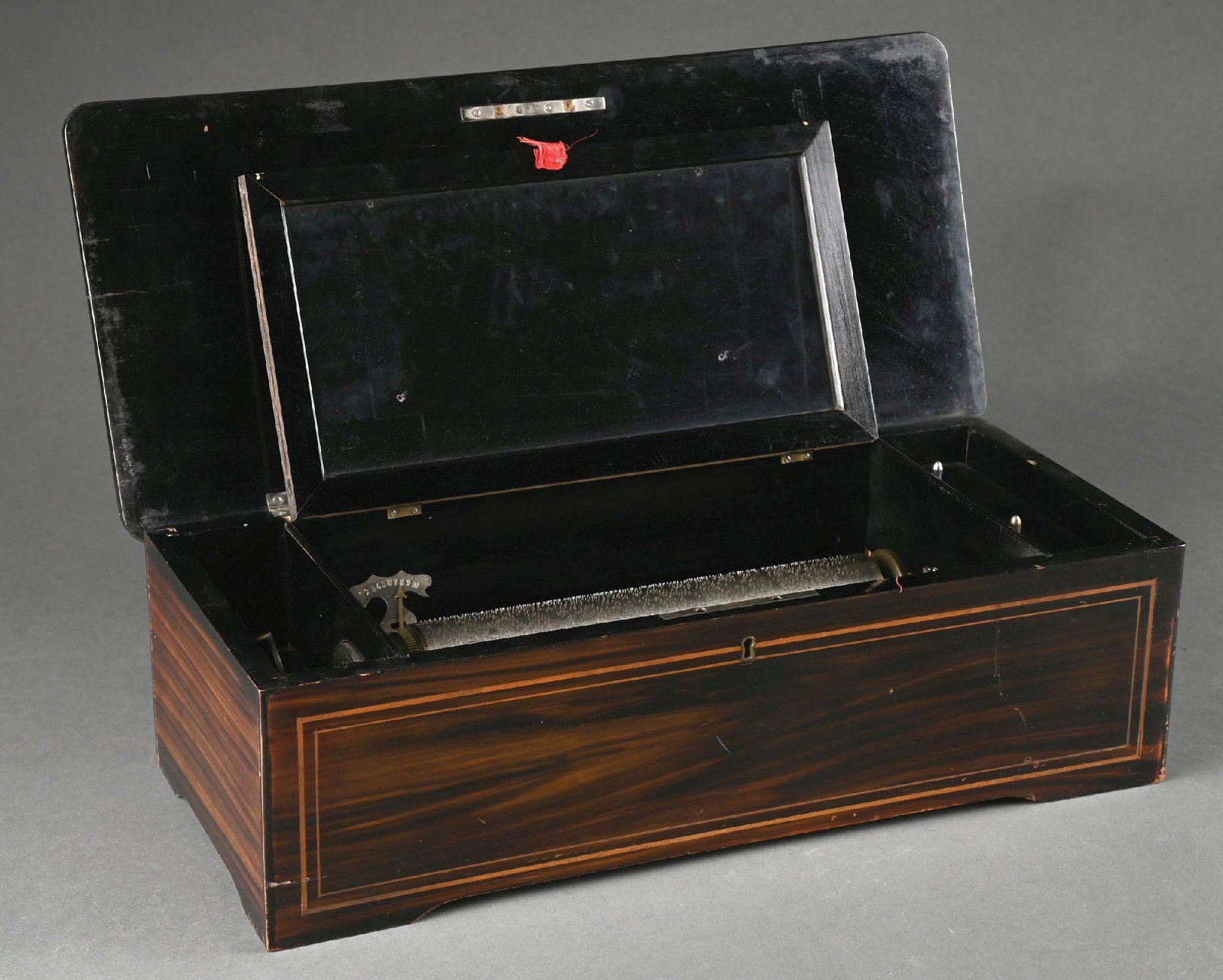 INLAID WOOD CASE ANTIQUE MUSIC BOX: Ten tune Swiss music box. Good working condition with inlaid lid. Condition: (Excellent). Dimensions: 21" x 8 - 1/4" x 6 - 1/4".