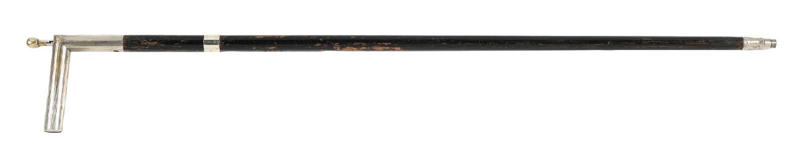 ANTIQUE DRESS GUN CANE: C. 1890s. A dress gun cane, likely .22 caliber, featuring a plunger-operated mechanism. The cane has an ebonized oak shaft and a bi-metal ferrule. The mechanism is reported to be in working condition.