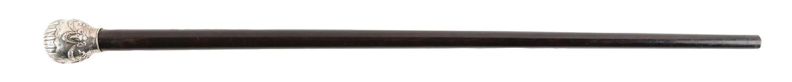 ANTIQUE WALKING STICK DAGGER WITH SILVER-PLATED KNOB HANDLE AND EBONY SHAFT: C. 1890–1915. Walking cane featuring a twist-off knob that reveals a dagger, and a repoussé-decorated metal ball-form handle with stylized floral and foliate motifs and radial fluting at th