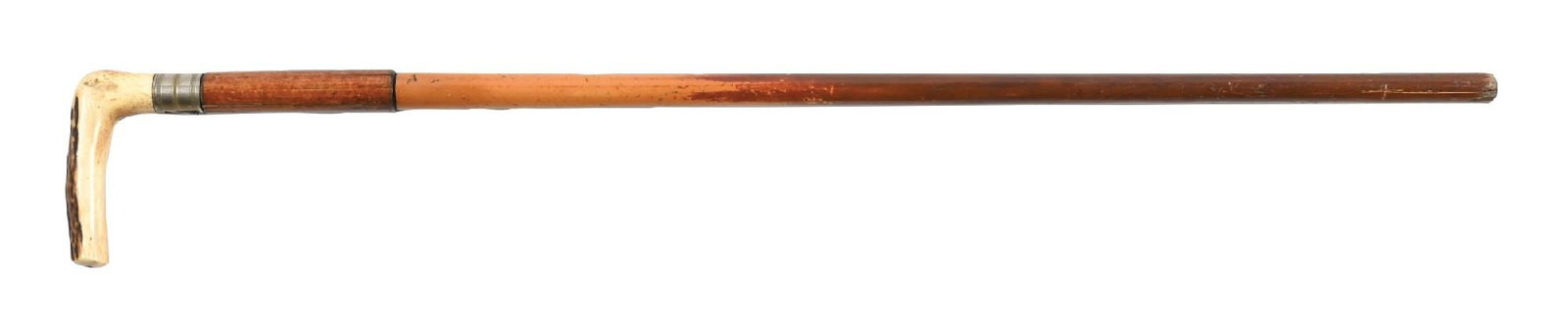 19TH CENTURY GENTLEMAN'S CANE: C. 1880–1900. A rare and unusual gentleman’s cane with the dual function of a .38 caliber shotgun. The shaft is formed as a stout reed concealing the gun barrel. The carved antler handle i