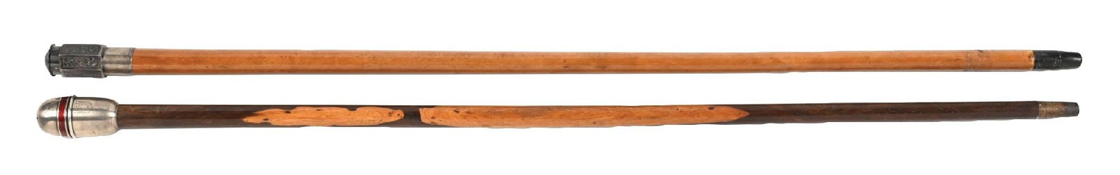 COLLECTION OF 2: STERLING VINAIGRETTE CANES: (A) C. 1900. An ornate silver vinaigrette knobbed cane featuring a naturally aged patina. The handle is mounted on a honey-colored wooden shaft showing typical surface scratching from use,
