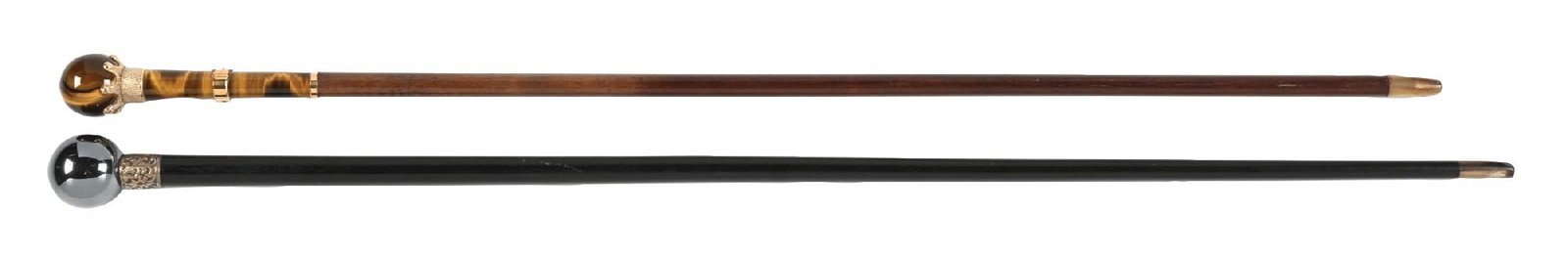 COLLECTION OF 2: TIGER EYE DRESS CANE & HEMATITE KNOB DRESS CANE: (A) C. 1880-1910. A hematite knobbed cane with an ornate silver-toned metal collar with an ebony hardwood shaft and horn ferrule. The ferrule has a polished chip, and a mild surface scratching on the