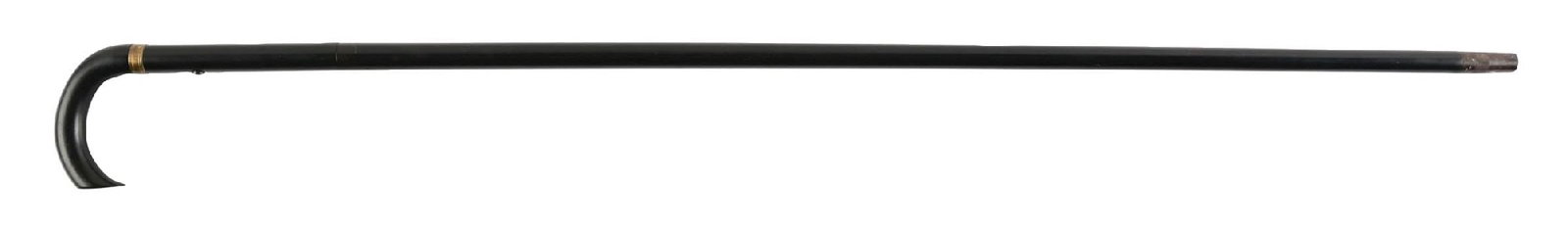 ANTIQUE METAL GUN CANE: C. 1890–1920. Concealed firearm walking cane featuring a curved crook handle mounted to a black ebonized hardwood shaft with brass collar and internal metal firing mechanism. The cane separates 