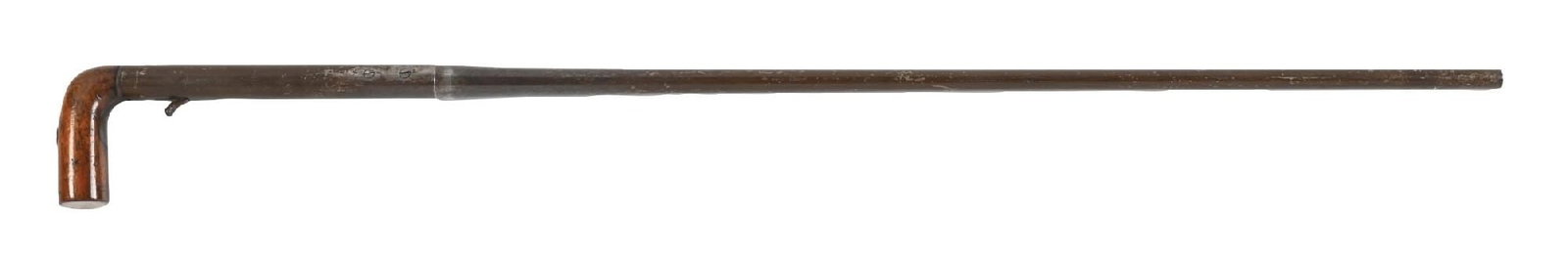 ANTIQUE GUN CANE: C. 1800s. A neat mechanical grease gun cane featuring a mahogany handle, metal barrel shaft, and trigger mechanism. The cane loads by twisting the barrel to open. The cane has typical age-related
