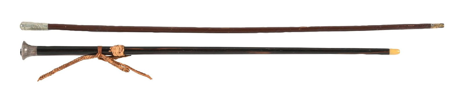 COLLECTION OF 2: MILITARY BATON CANES: (A) C. 1900s U.S. military baton cane featuring a silver-topped handle with a U.S. crest, mounted on a dark wooden shaft with a horn ferrule. The cane retains its original leather strap. The silver