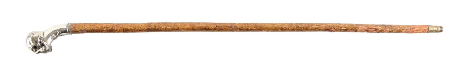 ANTIQUE WALKING CANE W/ SILVER-PLATED SKULL HANDLE AND WOOD SHAFT: C. 1900–1930. Figural walking cane featuring a silver-toned crook handle in the form of a skull with cutout hollow eye sockets, along with a molded crossbones detail at the neck. The handle