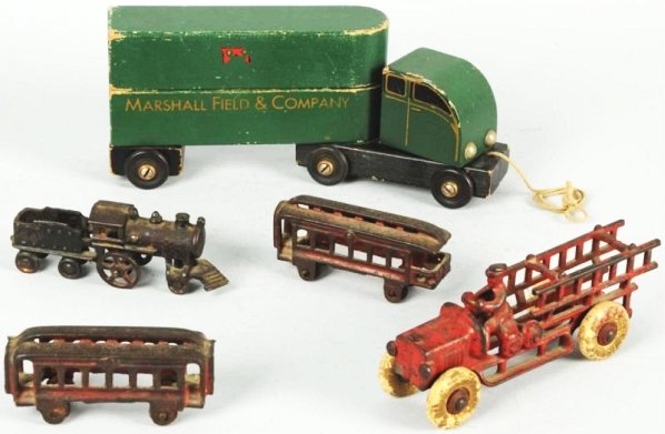Lot of 3: Vintage Cast Iron & Wooden Vehicles.: Includes one three-piece cast iron floor train, one Hubley cast iron fire ladder truck, and one three-piece wooden Marshall Field & Company advertising truck. Various conditions. Condition (Very Good)