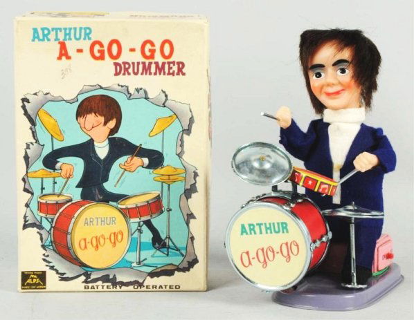Arthur A-Go-Go Drummer Battery-Op Toy.: Japanese. Made by Alps. Working. This was made as an unlicensed Beatles item and clearly depicts Ringo Starr on the drums. Toy is bright purple and comes with original cardboard header piece. and in u