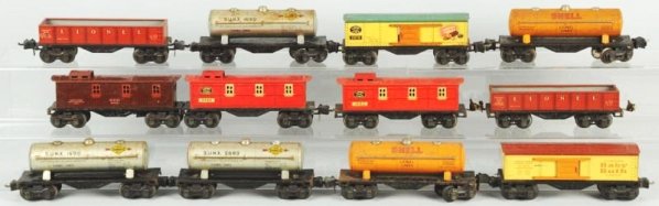 Lot of 12: Lionel 2600 Series Freight Train Cars.: Pre-war. O-gauge. Includes three cabooses and nine other freight cars, all with black journal boxes. A few cars are rough overall. Condition (Very Good).