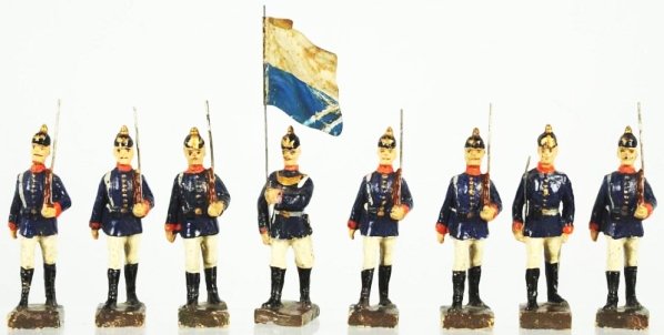Lot of 8: Lineol 9cm Marching Group.: Blue and white uniforms. Includes a flag bearer. Condition (Very Good - Excellent).