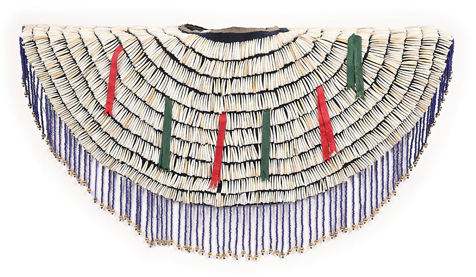 PLATEAU WOMEN'S YOKE: Early 20th century. Navy blue trade clothe covered with dentalium shells, accented with green and red ribbon. Strands of blue beads extend down to a larger brass bead used as a finial (beads a later
