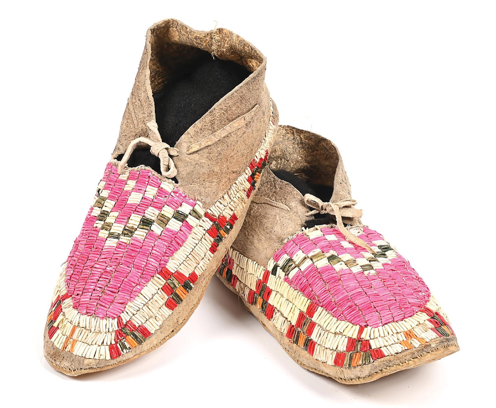 SIOUX (LAKOTA) QUILLED MOCCASINS: With an overall geometric pattern completely done in quillwork. Parfleche soles. Colors: pink, white, grey, red, orange Dimensions: 10 - 1/2" L.