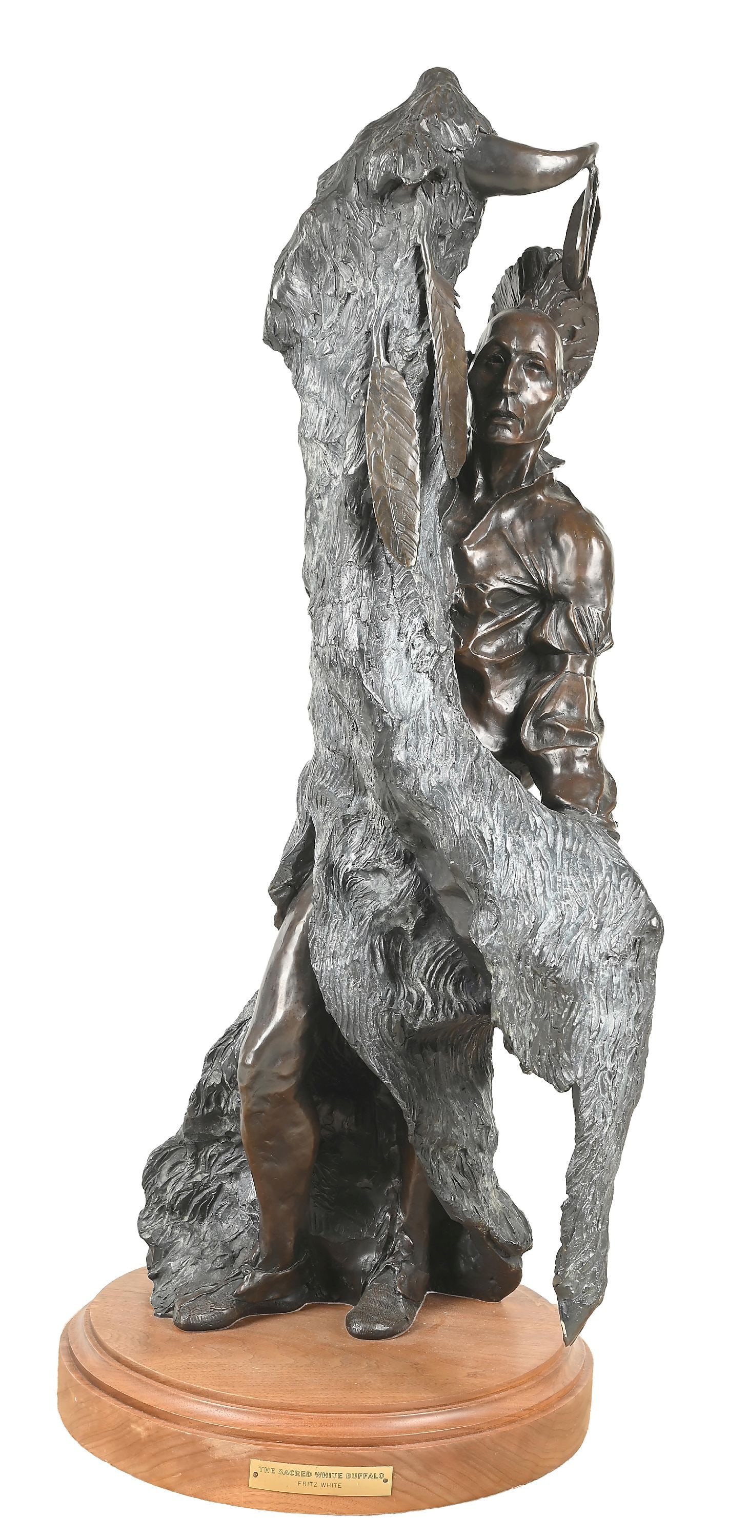 FRITZ WHITE (AMERICAN, 1930-2010): The Sacred White Buffalo bronze 13-1/2" L x 18" W x 32" H with stand: 35" H. signed on back "Fritz White, 2/15" Depicting a Pawnee man holding a white buffalo pelt, including the horns. Dimensions: 13
