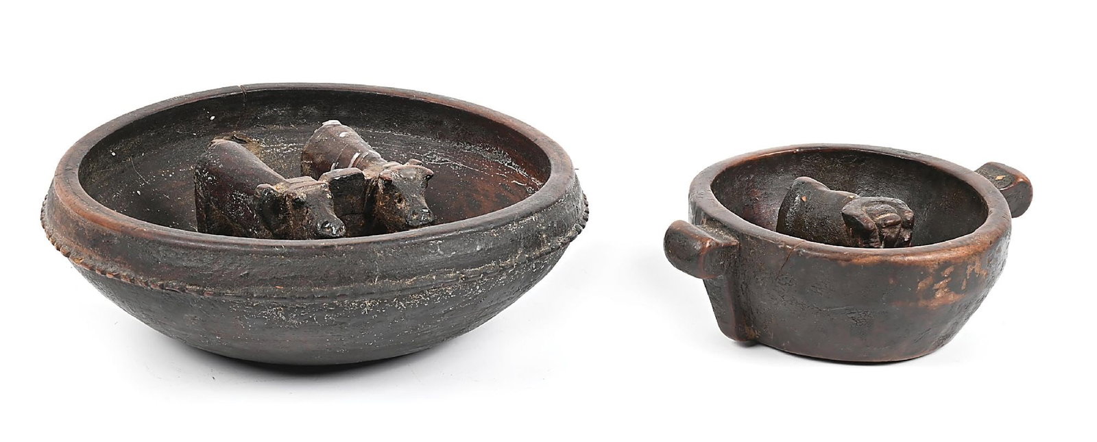 LOT OF 2: BOLIVIAN WOOD BOWLS: Each hand-carved, the largest containing two oxen and yoke, the smaller containing one bull. Largest - 9-1/2" Dia. x 3" T Dimensions: Largest: 9 - 1/2" Dia. x 2 - 7/8" T.
