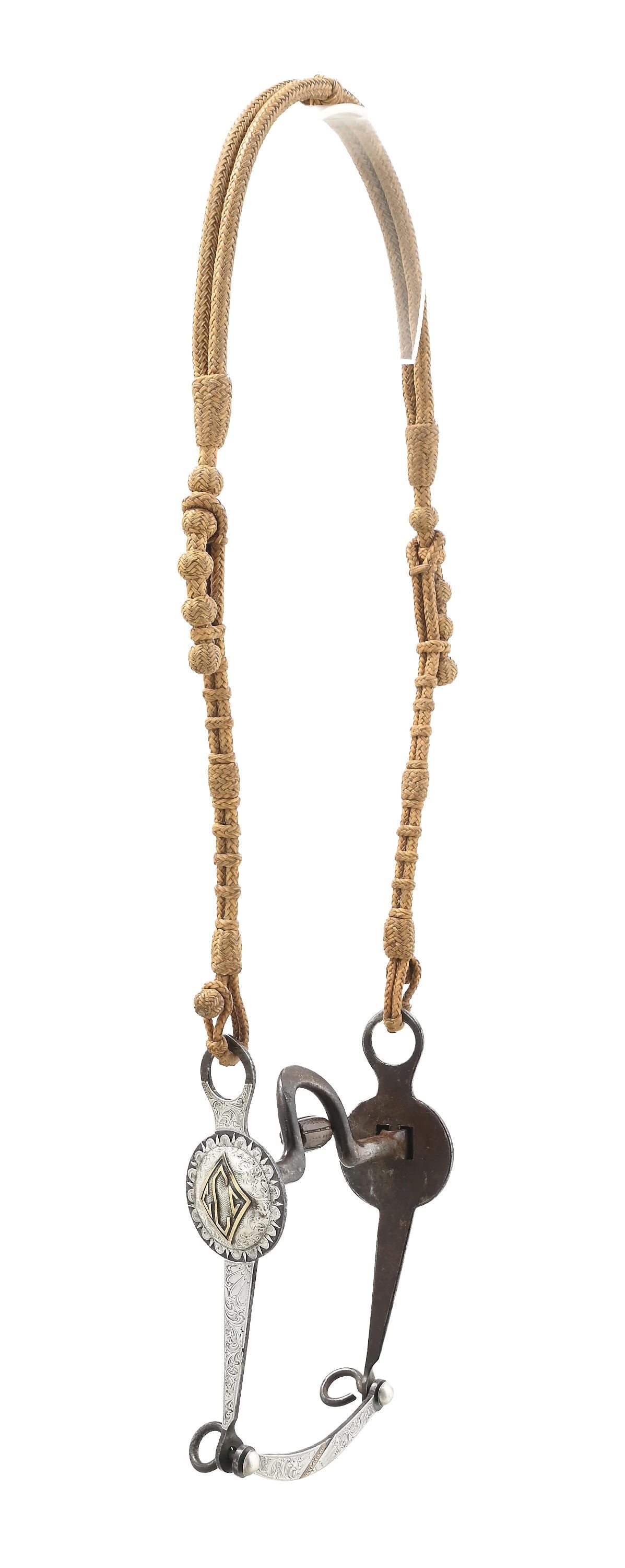 RAWHIDE BRAIDED CALIFORNIA STYLE HEADSTALL: Braided headstall by master maker Luis Ortega. Attached is a loose jaw, medium port Mexican bit, possibly by Grijalva with gold "CCC" initials to the side. Dimensions: 6" x 21".