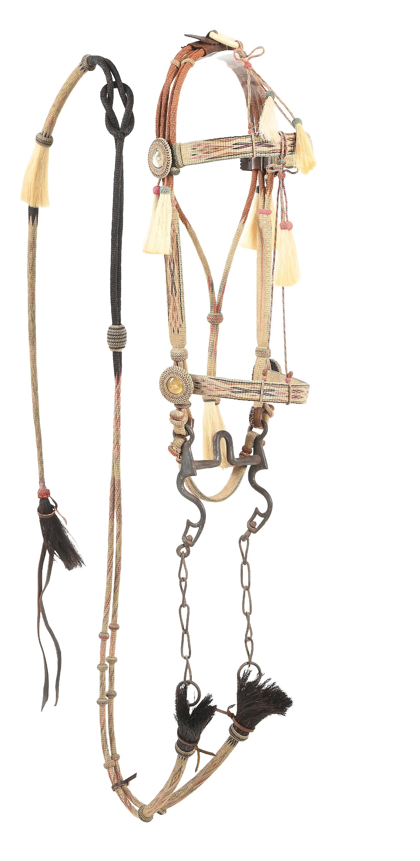 MONTANA PRISON HORSEHAIR BRIDLE: A fine hitched horsehair bridle with the typical elements of Deer Lodge prison. Diamond and "X" patterns on a natural cream colored background and pink, red, green, yellow, and blue accents. Pink knot