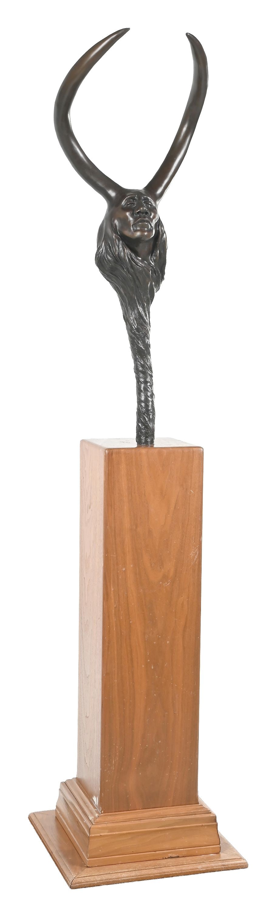 FRANK HOWELL (1937-1997): Bronze bust of a Native American signed bottom front "Frank Howell", dated 1995 limited edition 4 of 15 13-3/4" W x 33-3/4" H with stand: 70-3/4" H With stylized prong headdress, and the figure's hair