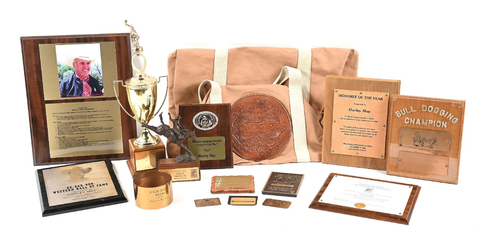 LARGE LOT OF HARLEY MAY TROPHIES: Various plaques and awards to Pro Rodeo world champion Harley May. Includes his gold lifetime member cards to the PRCA and Pro Rodeo Hall of Fame. Provenance Ex. Harley May Dimensions: Largest: 30" x 