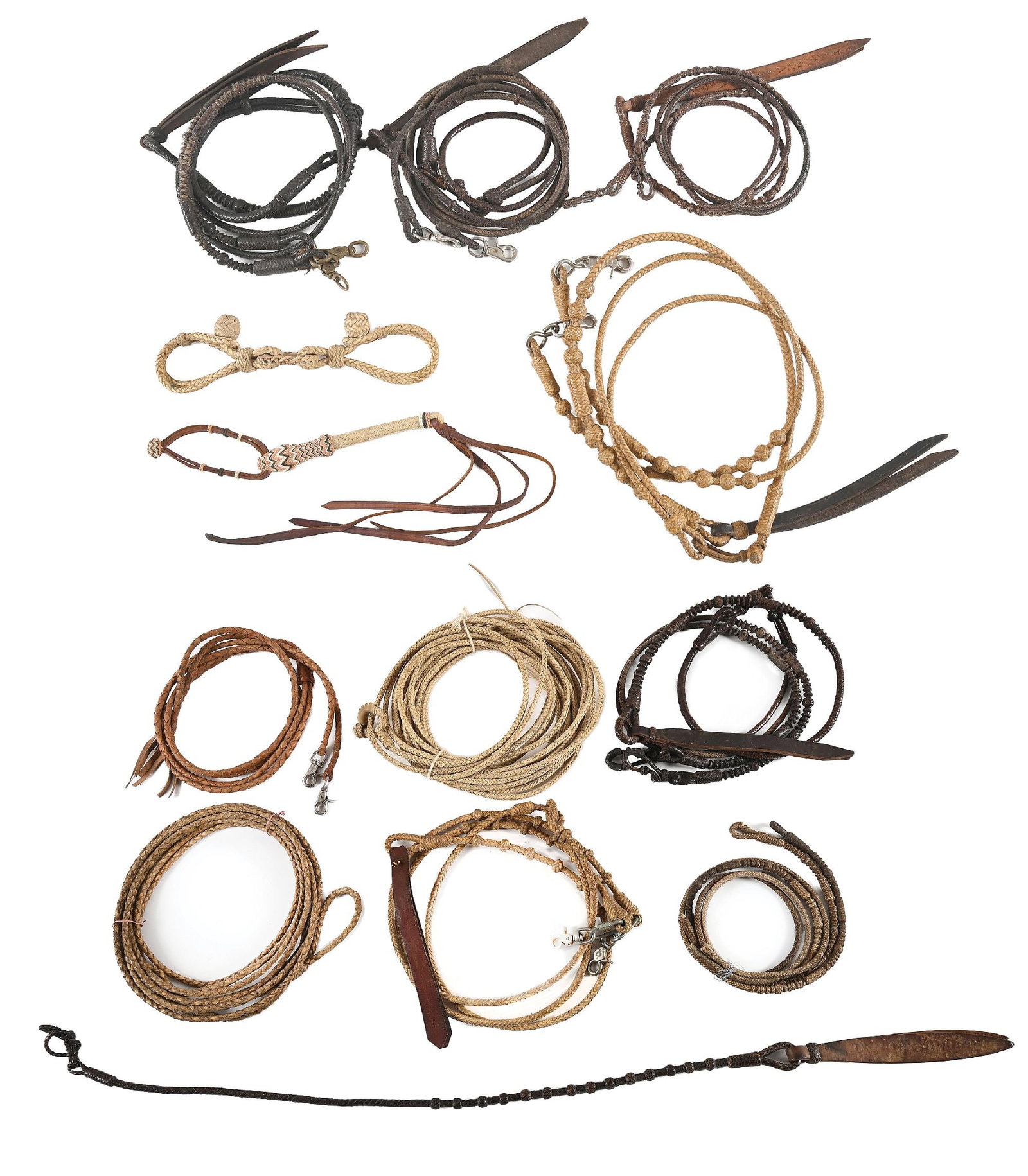 LOT OF 13: HARLEY MAY VARIOUS RAWHIDE REINS AND REATAS: Lot of mixed braided rawhide and kangaroo reatas, reins, and hobbles. Provenance Ex. Harley May