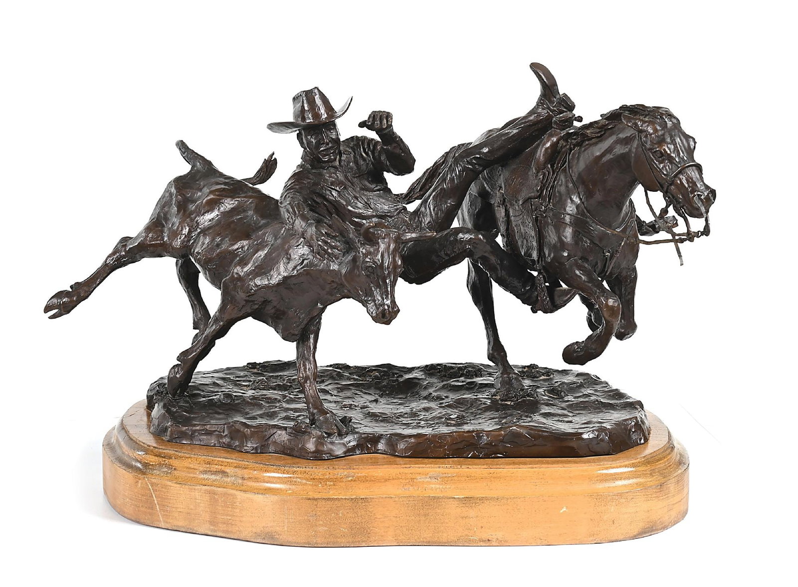 BETTY SALETTA BRONZE SCULPTURE OF HARLEY MAY STEER WRESTLING: Harley Bronze sculpture with dark brown patina Signed, dated 1982, titled, and numbered 1/25 on base 17-3/4" x 12-1/2" x 10" Mounted on a beveled wooden stand With stand: 18" x 13" x 12" Provenance
