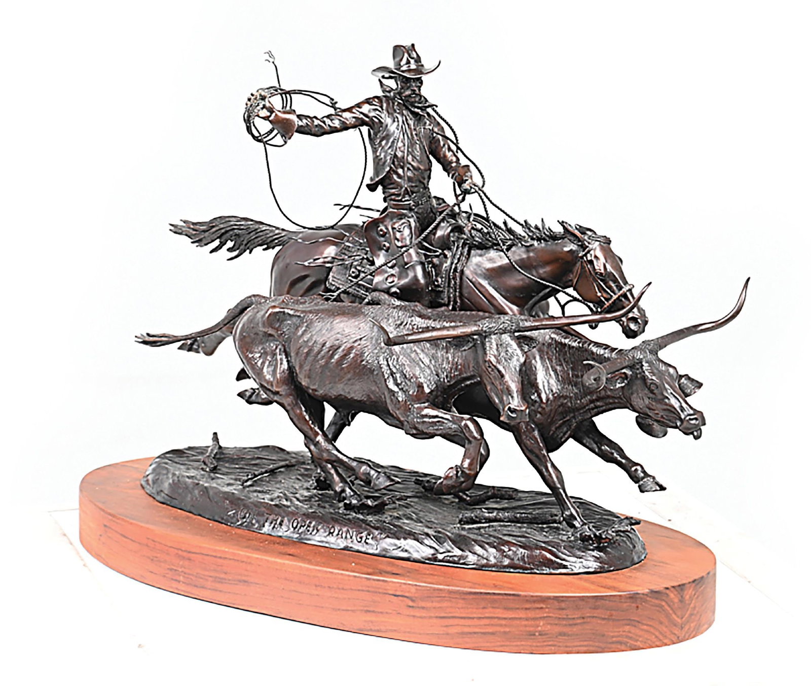 JIM STUCKENBERG (1943 -): On the Open Range Bronze with dark brown patina with natural oxidation Depicting a cowboy on the horseback driving a pair of longhorns Signed, dated and numbered on the base: Jim Stuckenberg, '06,