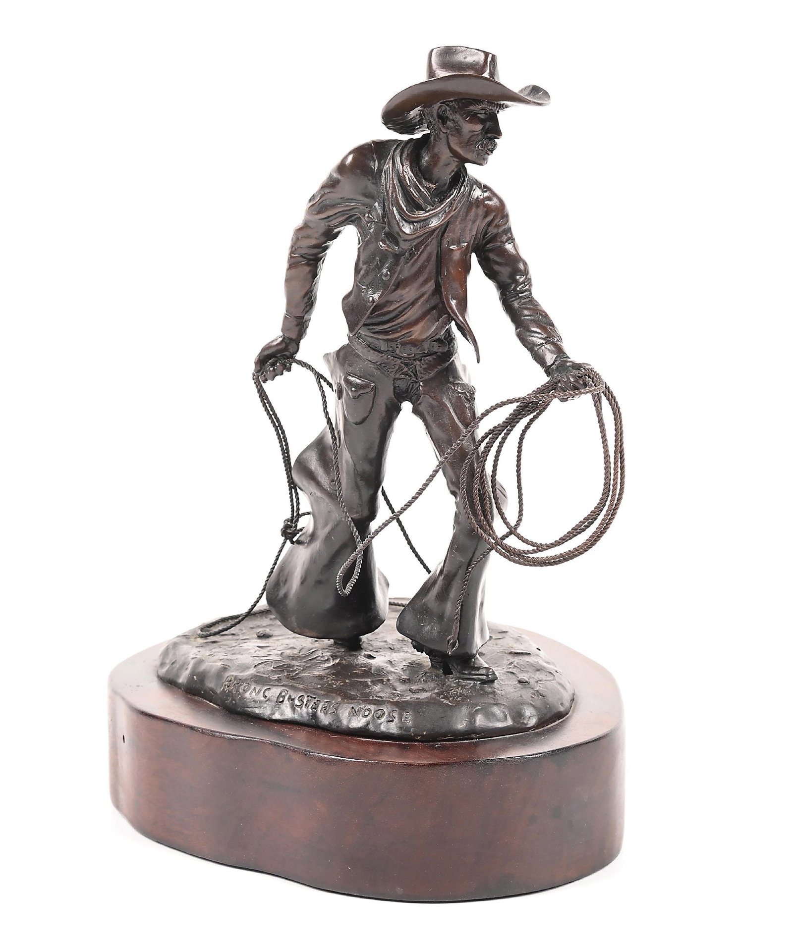 JIM STUCKENBERG (1943 -): Bronc Buster Noose Bronze with dark brown patina 8-1/2" x 5" x 8-1/2" Depicting a cowboy figure with a lasso mounted on the wooden base Titled on the front Signed, and numbered on the base: Jim