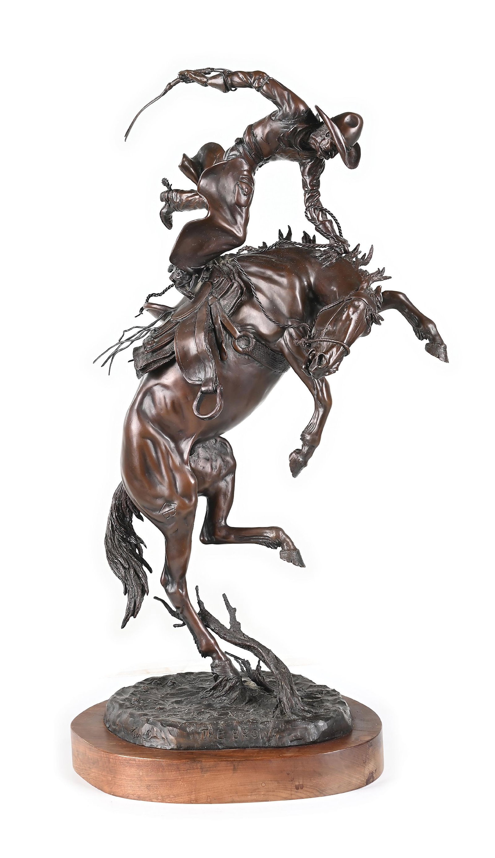 JIM STUCKENBERG (1943 -): The Bronc Bronze with dark brown patina with natural oxidation 12" x 9" x 22-1/2" It depicts a dramatic scene of a cowboy figure taming a wild bucking horse Titled and numbered 5/30 on the front