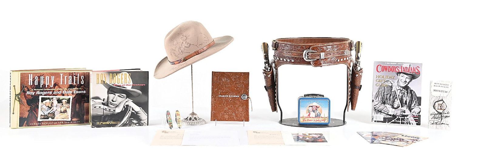LARGE LOT OF ROY ROGER MEMORABILIA INCLUDES (2) COLT SAA, HOLSTER RIG.: The highlight of this collection features the two gun Colt SAA revolvers with the hand tooled double holster Buscadero rig. The rig comes with a letter from Legends of Leather who hand crafted this