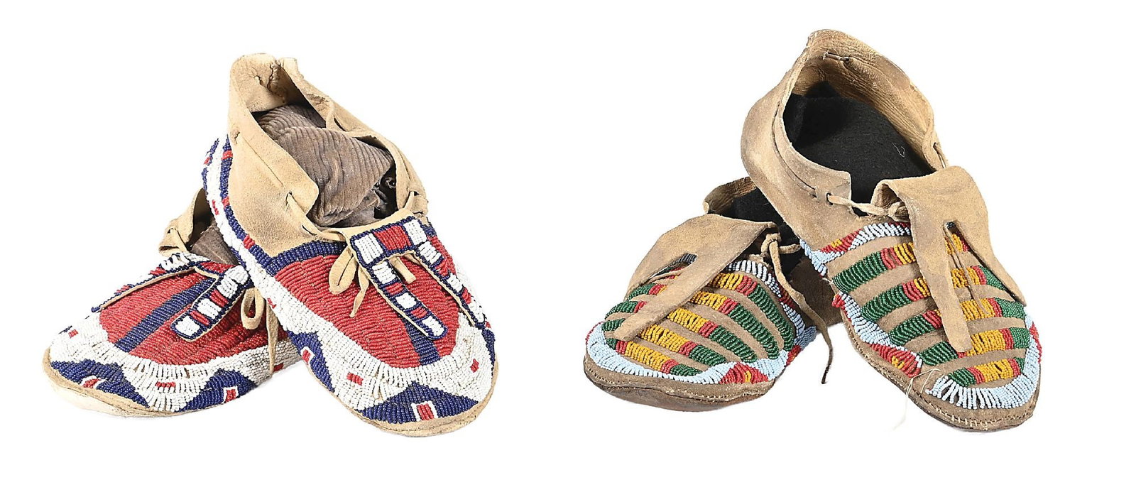 LOT OF 2: SIOUX (LAKOTA) PAIRS OF MEN'S MOCCASINS: Mid-20th century. (A) With worn parfleche soles, fully-beaded uppers with a buffalo track design and a band of geometric pattern around the edge. Colors: white-center red, dark blue, white (B) Worn