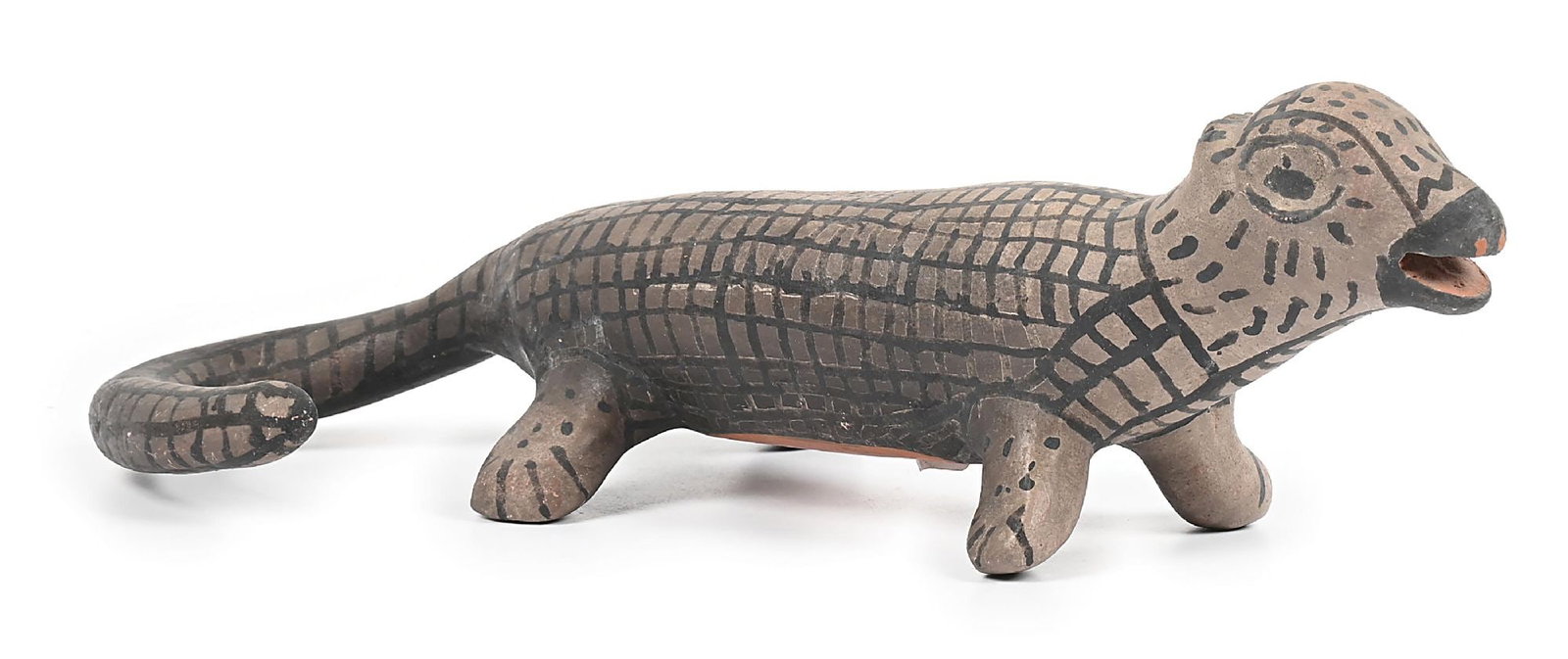 COCHITI POTTERY LIZARD BY DAMACIA CORDERO (1905-1989): Remnants of signature on base. A fanciful interpretation of a lizard with cross-hatched designs covering the body and tail. Dimensions: 13" x 6 - 1/4" x 4".