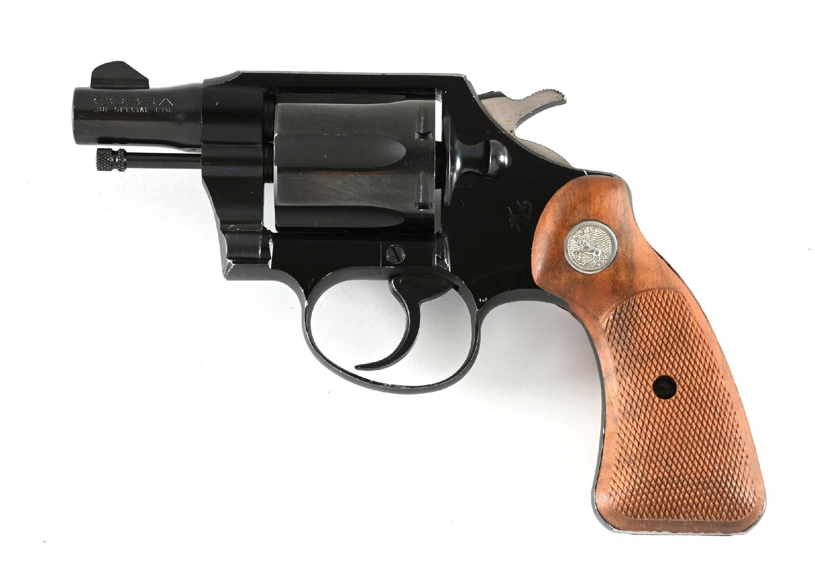 (C) COLT COBRA DOUBLE ACTION REVOLVER WITH BOX (1952): Dates to 1952. This 3rd year production gun still sports the alloy frame, dual tone blue finish, checkered walnut grips with silver medallions, and comes with a mismatched box. CONDITION: Excellent.