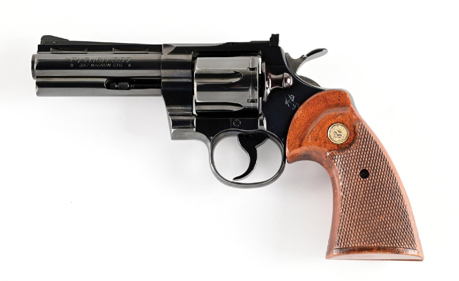 (C) COLT PYTHON .357 MAGNUM DOUBLE ACTION REVOLVER (1967).: Classic Colt snake gun with vent rib, serrated ramp front sight, adjustable square notch rear sight, and Colt legends. Colt "smiley face" walnut grips with checkered panels. CONDITION: Excellent, reta