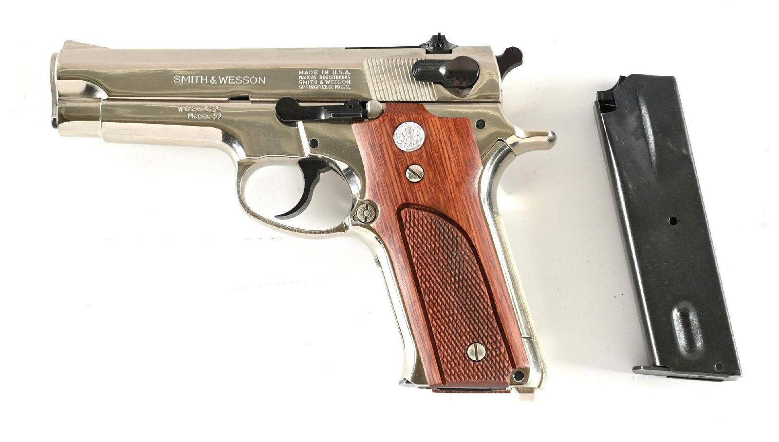 (C) SMITH & WESSON MODEL 59 SEMI-AUTOMATIC PISTOL.: Dates from 1972-73. Features the dual tone nickel finish with blued smalls, checkered walnut grips with silver medallions, and adjustable target rear sight. Comes with spare blued magazine. Includes a
