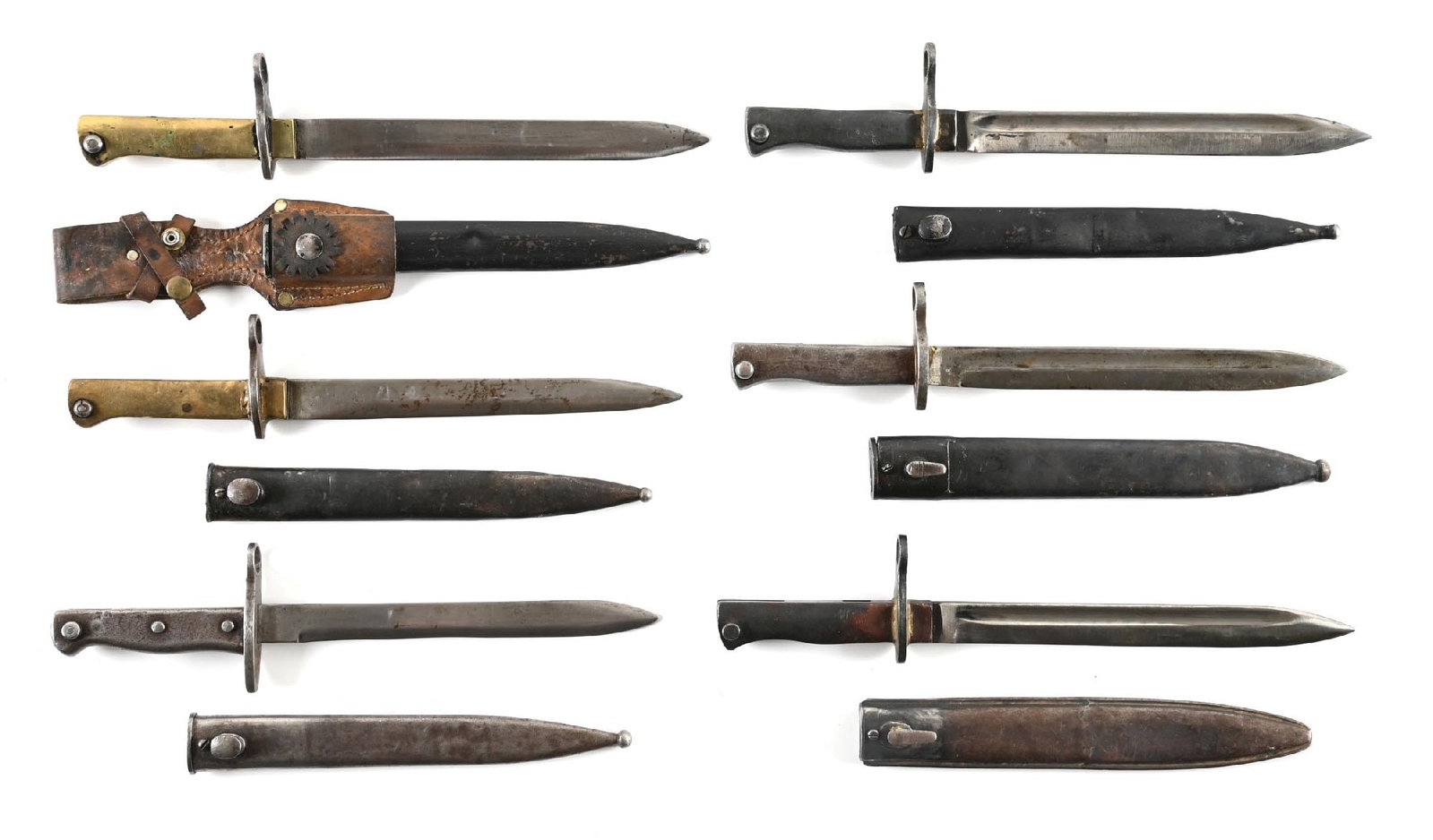 LOT OF 6: ERSATZ BAYONETS.: Lot consists of six ersatz bayonets. All have scabbards and only one has a leather frog. Two have brass handles. All exhibit varying degrees of wear and patina with blemishes. Some scabbards exhibit
