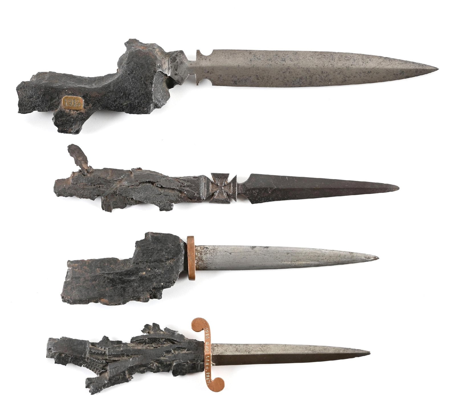 LOT OF 4: GERMAN WWI TRENCH ART SHRAPNEL KNIVES.: Lot consists of four German World War I trench art shrapnel knives or letter openers. (A) Largest measuring 12" overall. Unmarked blade with shrapnel handle marked "1914" on a brass plaque. (B)