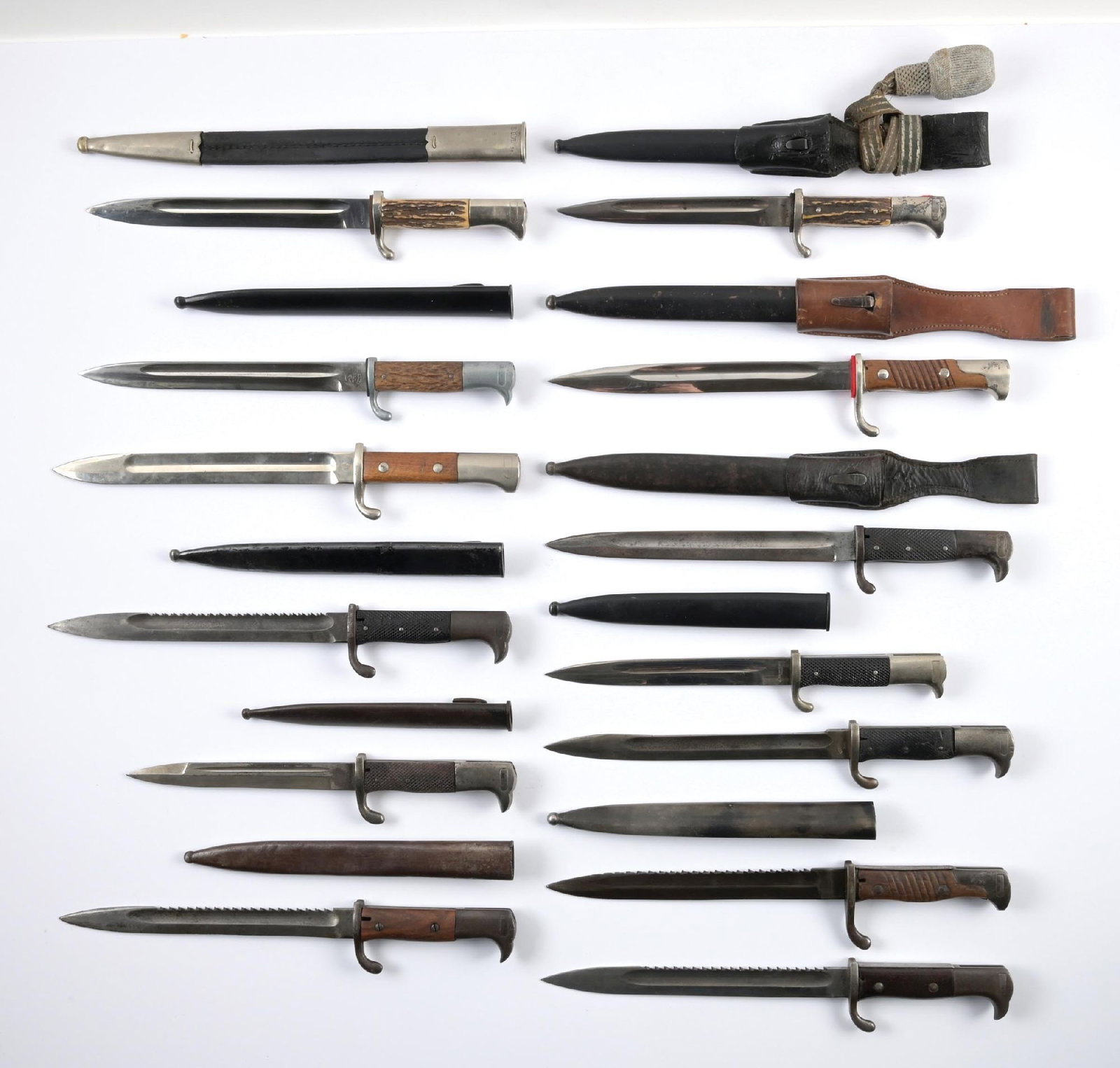 LOT OF 13: GERMAN WWII DRESS BAYONETS.: Lot consists of ten German dress bayonets. Three are police style with stag grip scales, one is a cut down M98/05 bayonet, and four are sawbacks. One police bayonet has a leather frog and protepee.