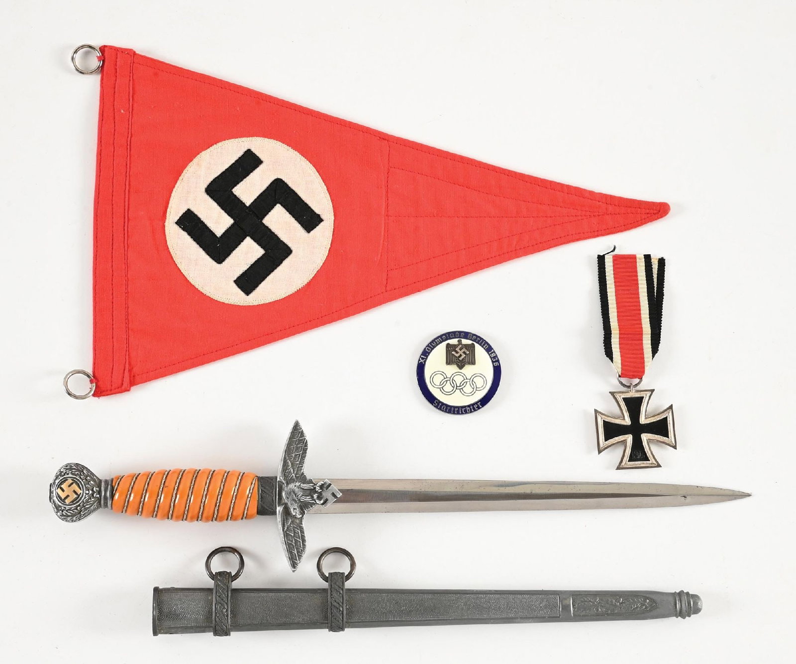 LOT OF GERMAN WWII LUFTWAFFE DAGGER, EKII, OLYMPIC MEDAL, AND PENNANT.: Lot contains a Luftwaffe dagger with an unmarked blade with light scattered marks and visible cross graining. Orange trylon grip has a 3/4 inch piece which was broken and re-glued on bottom, wire is
