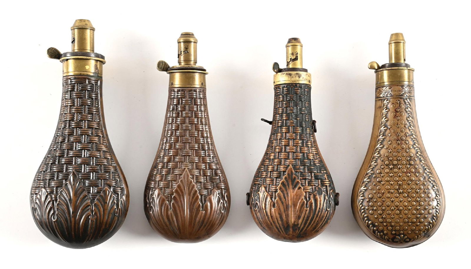 LOT OF 4: JAMES DIXON & SONS SHEFFIELD BASKET WEAVE POWDER FLASKS.: All of these flasks are large size and all maker stamped. All display a traditional pattern with variations of the flourish. The first example measures approximately 7" displaying the weave pattern wi