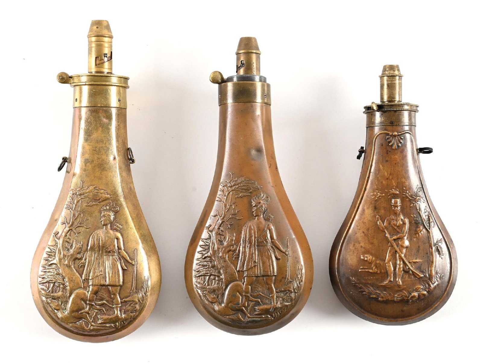 LOT OF 3: BRASS POWDER FLASKS WITH FRONTIER HUNTERS. (1 of 2)