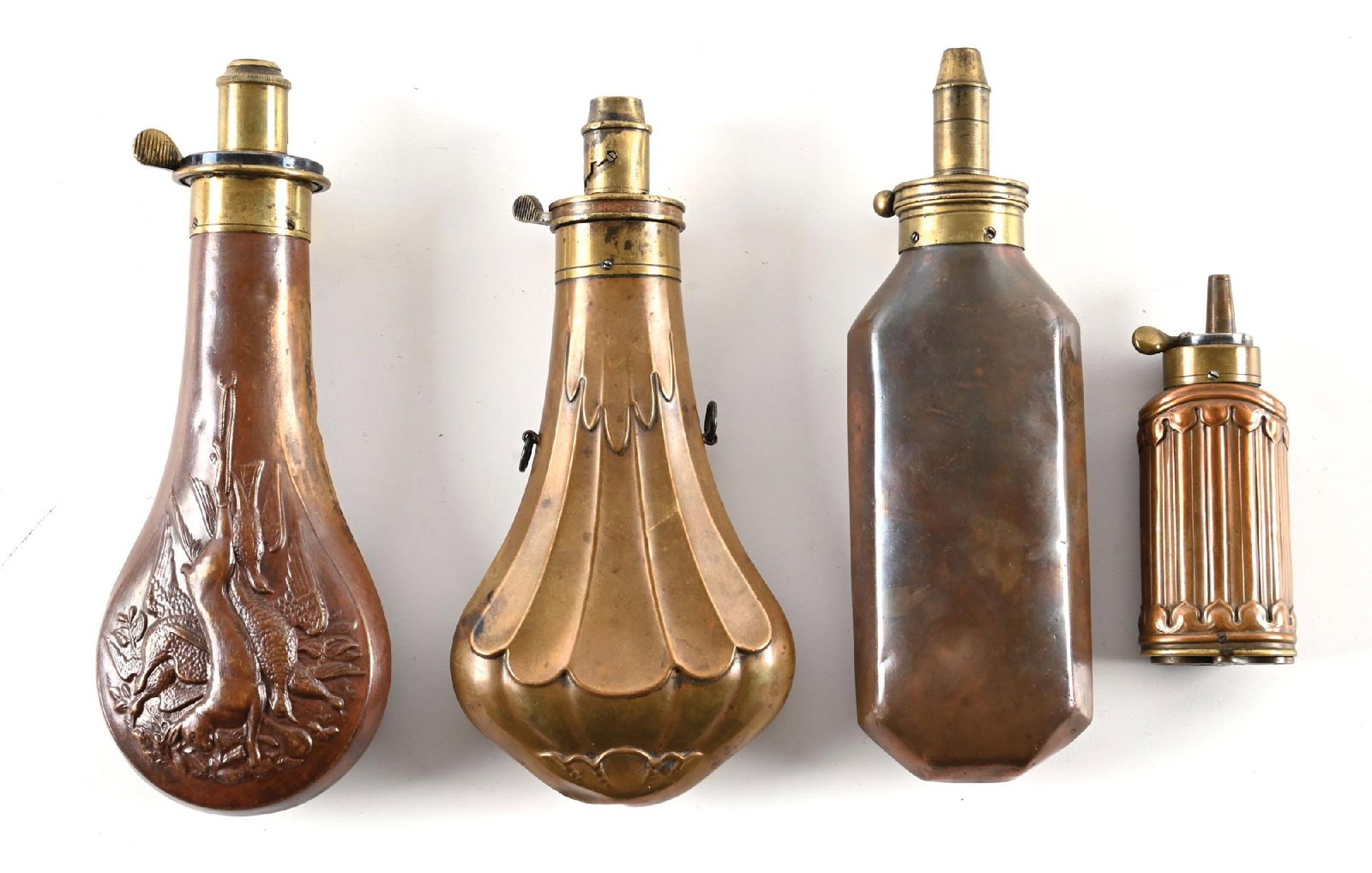 LOT OF 4: CAPTIVATING BRASS POWDER FLASKS. (1 of 2)