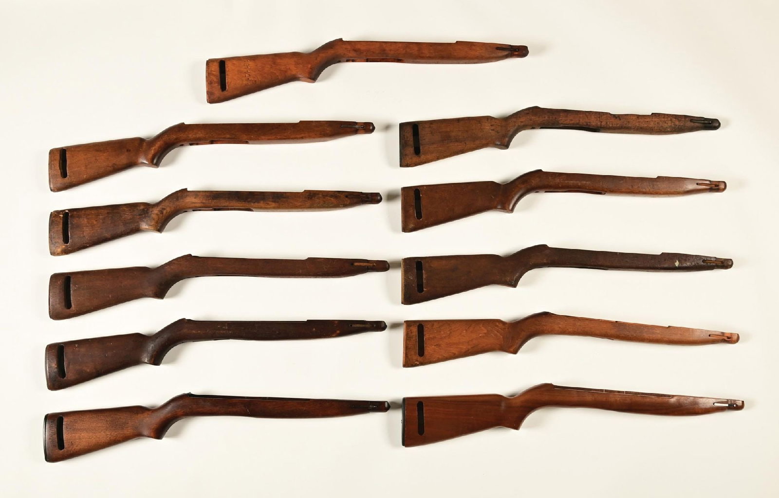 LOT OF 11: M-2 CARBINE FAT BELLY STOCKS.: One has the Ordnance Wheel stamp and two have drawing or serial number stamps, the remainder are not inspected. CONDITION: All rate very good or better.