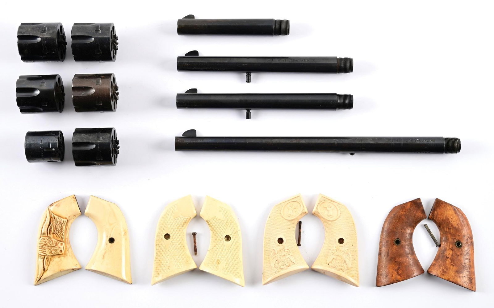 LOT OF COLT SAA REVOLVER PARTS.: This lot consists of four barrels, six cylinders and four sets of grips. BARRELS. All are blue and have excellent bores. A. Pre War style 4 3/4", .45, single line address (shortened) , #4415. B. Post 